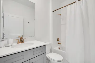 a white bathroom with a sink and a toilet at Ev2669 - Sunshine Escape Villa in Kissimmee
