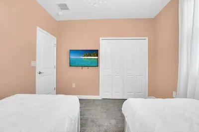 a bedroom with two beds and a window at Ev2669 - Sunshine Escape Villa in Kissimmee