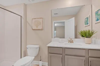 a bathroom with a toilet and a sink and a mirror at Ev2707 - Magic Getaway Villa in Kissimmee