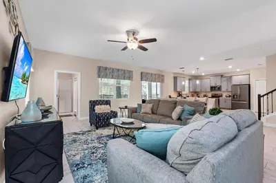 a living room with a couch and a flat screen tv at Ev2707 - Magic Getaway Villa in Kissimmee