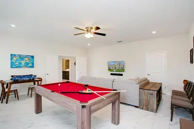a living room with a ping pong table at Ev2709 - Enchanted Retreat Villa in Kissimmee