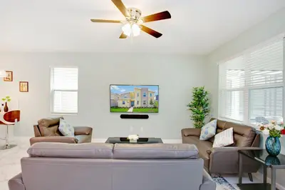 a living room with two couches and a ceiling fan at Ev2709 - Enchanted Retreat Villa in Kissimmee