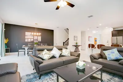 a living room with a couch and a table at Ev2709 - Enchanted Retreat Villa in Kissimmee