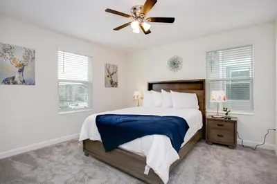 a bedroom with a bed and a ceiling fan at Ev2709 - Enchanted Retreat Villa in Kissimmee
