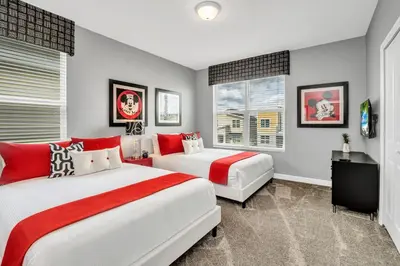 two beds in a bedroom with red and white at Ev2755Book - Golden Horizon Villa in Kissimmee