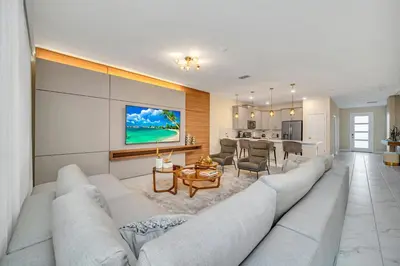 a living room with a large couch and a kitchen at Ev2826 - Magical Horizon Villa in Kissimmee