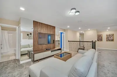 a living room with a white couch and a tv at Ev2826 - Magical Horizon Villa in Kissimmee