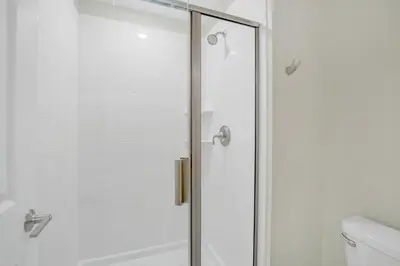 a shower with a glass door in a bathroom at Ev2861 - Sunshine Grove Villa in Kissimmee