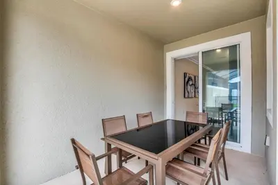 a dining room with a table and chairs at Ev2861 - Sunshine Grove Villa in Kissimmee