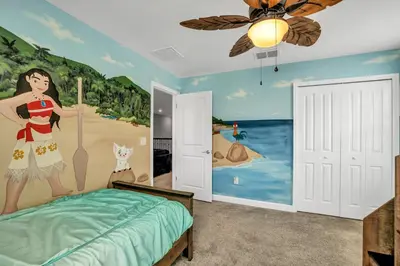 a bedroom with a mural of a woman on the beach at Ev2909 - Storey Lake Haven in Kissimmee