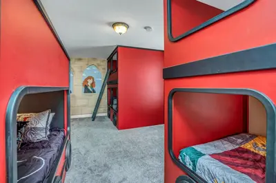 a red bus with two beds in a room at Ev2909 - Storey Lake Haven in Kissimmee