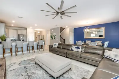a living room and kitchen with a couch and a table at Ev2909 - Storey Lake Haven in Kissimmee
