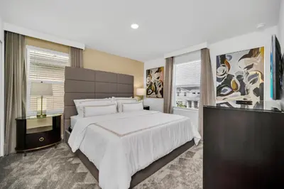 a bedroom with a large white bed and a window at Ev2989 - Serenity Palms Villa in Kissimmee