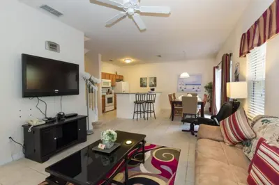 a living room with a couch and a flat screen tv at Ev3000 - Paradise Hideaway in Orlando