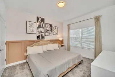a bedroom with a large bed and a window at Ev3007 - Lakeside Escape Villa in Kissimmee