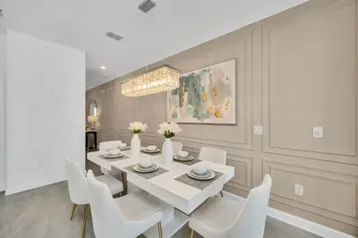 a dining room with a white table and white chairs at Ev3007 - Lakeside Escape Villa in Kissimmee