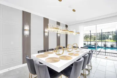 a dining room with a white table and chairs at Ev3009 - Grand View Retreat in Kissimmee