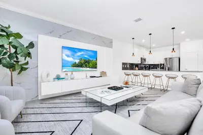 a white living room with a white couch and a table at Ev3009 - Grand View Retreat in Kissimmee