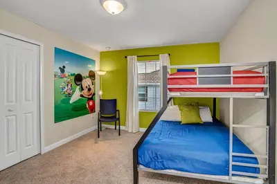 a bedroom with a bunk bed and yellow walls at Ev3097 - Lakeside Serenity Villa in Kissimmee