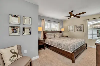 a bedroom with a bed and a ceiling fan at Ev3097 - Lakeside Serenity Villa in Kissimmee