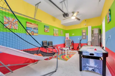 a room with a ping pong table and a net at Ev3115 - Sunset Bay Villa in Kissimmee