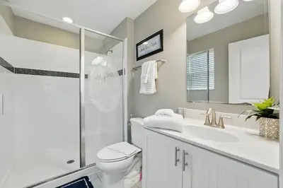 a bathroom with a toilet and a sink and a shower at Ev3115 - Sunset Bay Villa in Kissimmee