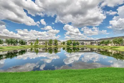 a reflection of clouds in a pond at an apartment complex at Ev3115 - Sunset Bay Villa in Kissimmee