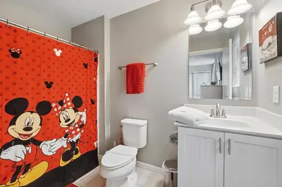a bathroom with a mickey mouse shower curtain at Ev3115 - Sunset Bay Villa in Kissimmee