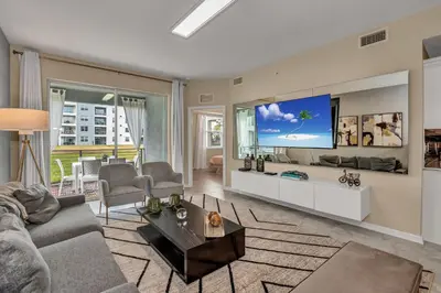 a living room with a couch and a tv at Ev101 - The Luxe Loft in Kissimmee