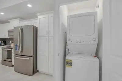 a kitchen with a refrigerator and a microwave at Ev101 - The Luxe Loft in Kissimmee