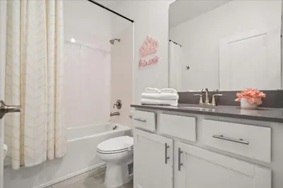 a white bathroom with a toilet and a sink at Ev4152 - Aventure Oasis in Kissimmee