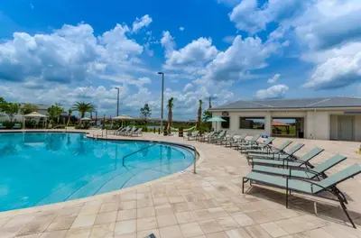 a swimming pool with lounge chairs in a resort at Ev4152 - Aventure Oasis in Kissimmee
