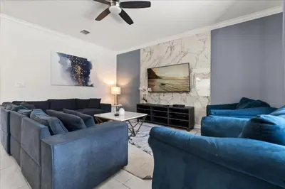 a living room with two blue couches and a table at Ev4152 - Aventure Oasis in Kissimmee