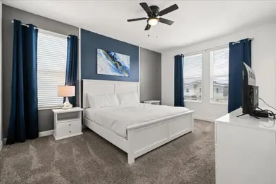 a bedroom with a bed and a ceiling fan at Ev4152 - Aventure Oasis in Kissimmee
