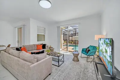 a living room with a couch and a tv at Ev4228 - Storey Retreat in Kissimmee