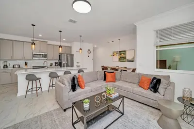 a living room with a couch and a kitchen at Ev4228 - Storey Retreat in Kissimmee