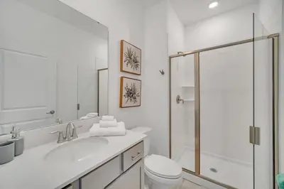 a white bathroom with a sink and a shower at Ev4228 - Storey Retreat in Kissimmee