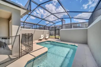 an indoor swimming pool with a glass ceiling at Ev4228 - Storey Retreat in Kissimmee