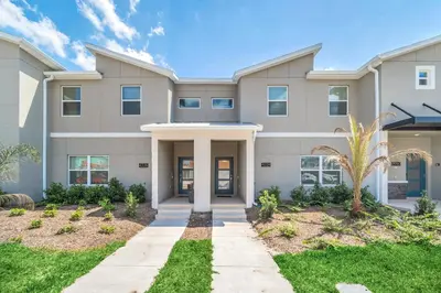 a large apartment building with a driveway at Ev4228 - Storey Retreat in Kissimmee
