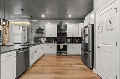 a kitchen with white cabinets and stainless steel appliances at 4324Prolouge in Kissimmee