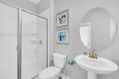 a bathroom with a toilet and a sink and a shower at Ev4569 - Storey Lake Serenity in Kissimmee