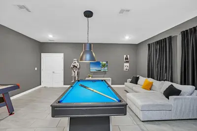 a living room with a pool table at Ev4569 - Storey Lake Serenity in Kissimmee