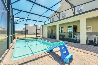 a swimming pool with a slide in a house at Ev4569 - Storey Lake Serenity in Kissimmee
