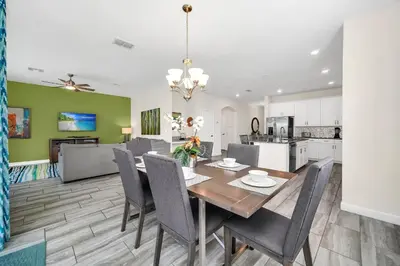 a kitchen and dining room with a table and chairs at Ev4710 - Regal Villa in Kissimmee