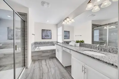 a bathroom with two sinks and a tub and a shower at Ev4710 - Regal Villa in Kissimmee