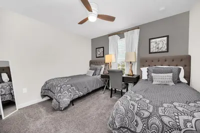 a bedroom with two beds and a desk at Ev4710 - Regal Villa in Kissimmee