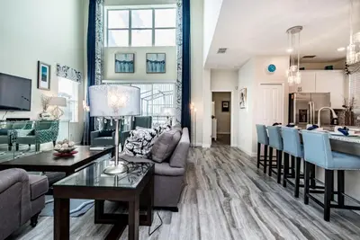 a living room with a couch and a table at Ev4755 - Tranquil Haven Villa in Kissimmee