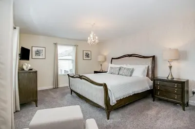 a bedroom with a large bed and a chandelier at Ev4778 - Paradise Cove Villa in Kissimmee