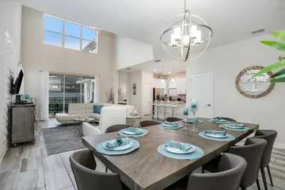 a dining room and living room with a table and chairs at Ev4778 - Paradise Cove Villa in Kissimmee