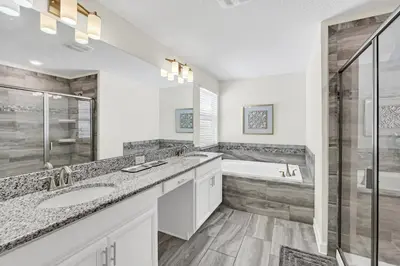 a bathroom with two sinks and a shower and a tub at Ev4795 - Kings Oasis in Kissimmee